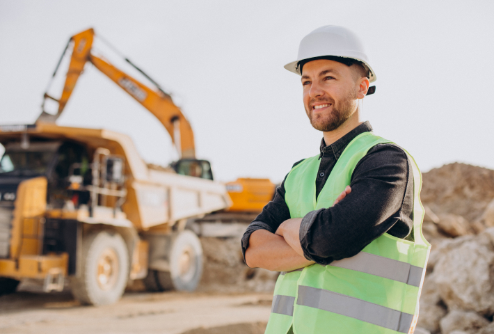Construction worker in safety gear at job site
